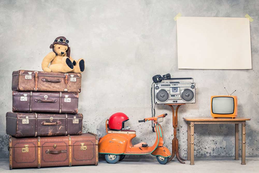 Vintage items including teddy bear with old suitcases, toy scooter, old radio and old tv
